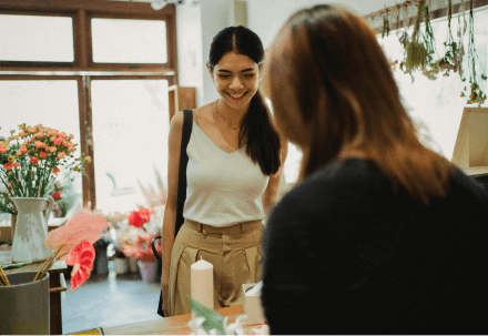 A customer buying some flowers in a florist