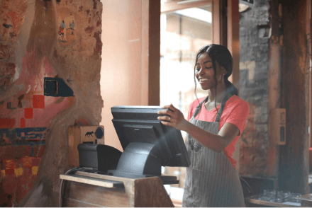 A retail staff member using the till to generate a bill