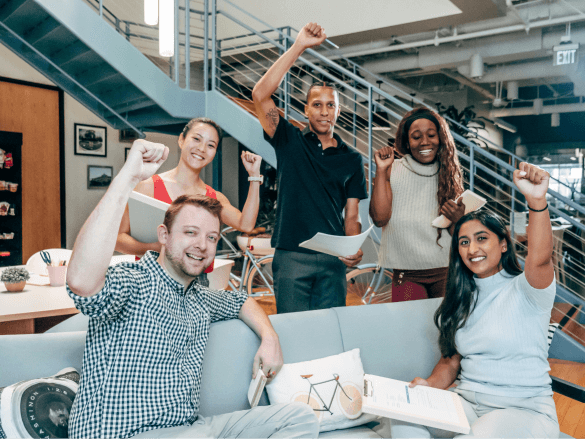 A happy team fist pumping the air