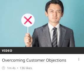 Screenshot of a training module from Academy point a man holding a sign. This module is about customer objections.