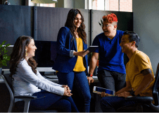 A team having an impromtu meeting at a desk