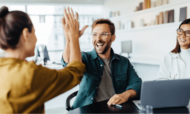 Two team members celebrating success with a high five