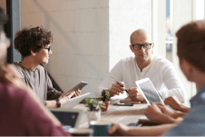 A meeting showing three people planning a project