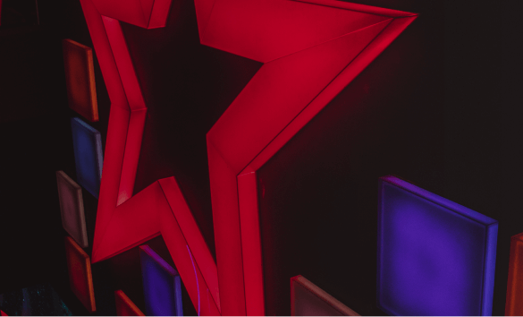 A wall covering in lit up square and star shaped lights, using the red and blue Cineworld brand colours